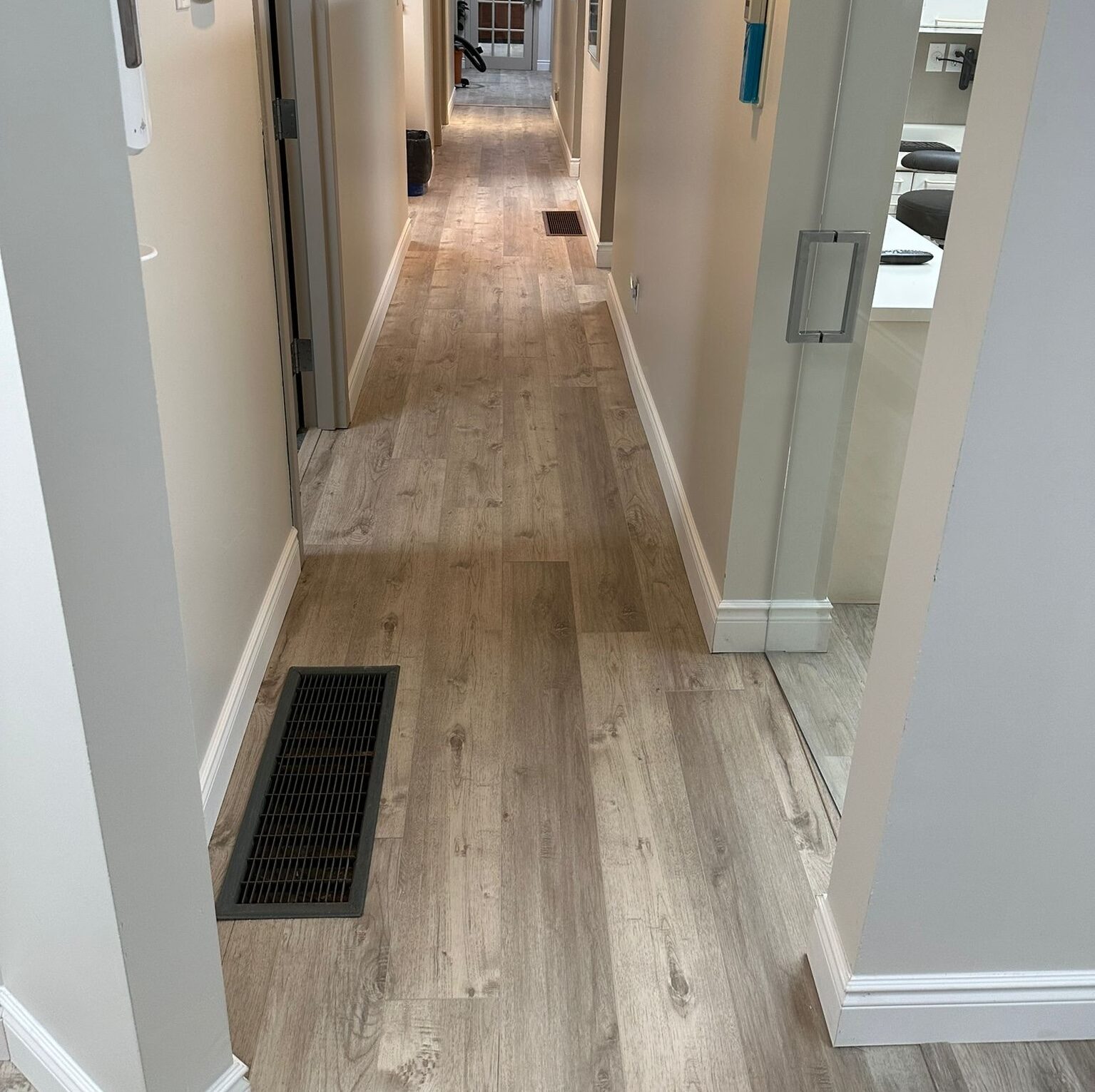 New wood-look flooring running through the hallway.