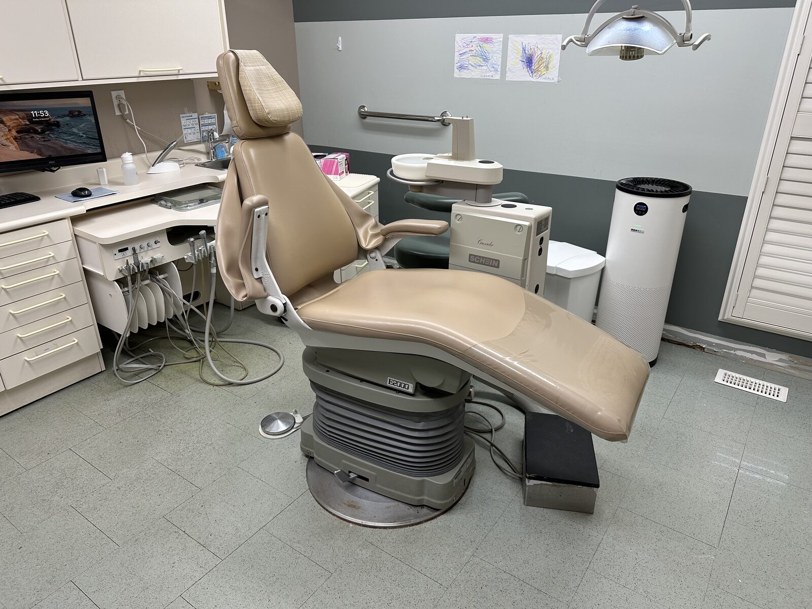 An operatory before the work, on the original speckled tile floor.