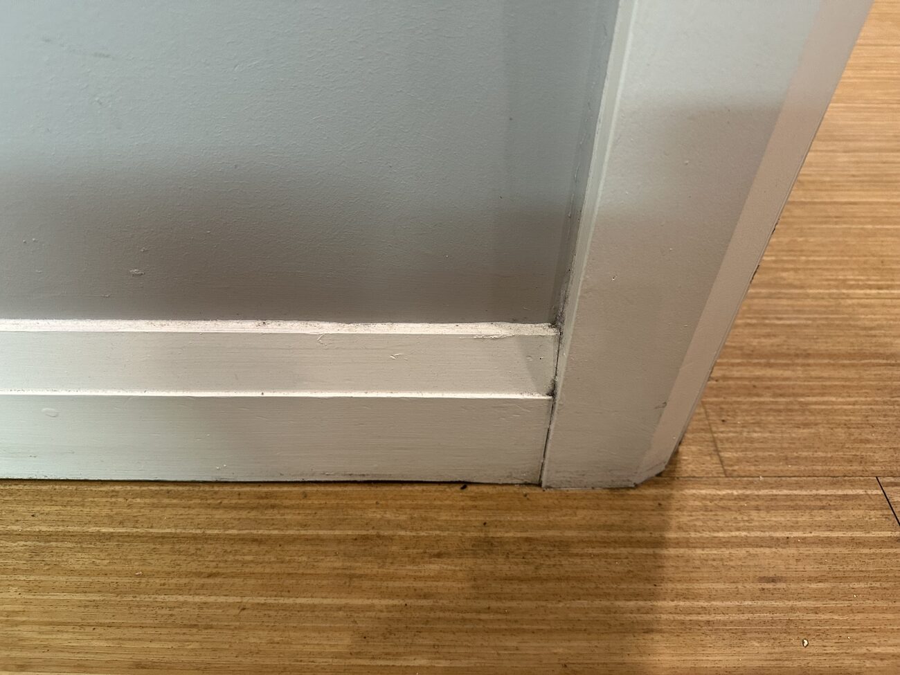 Worn flooring at the transition before replacement.