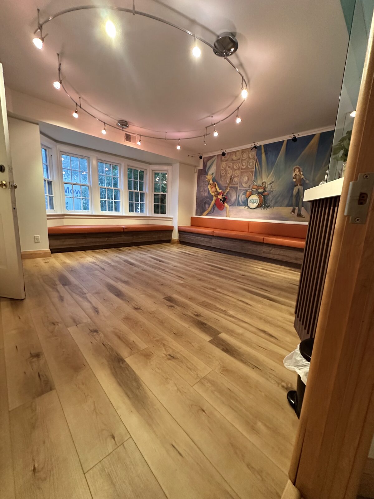 The finished waiting area with new flooring beneath the practice's mural.