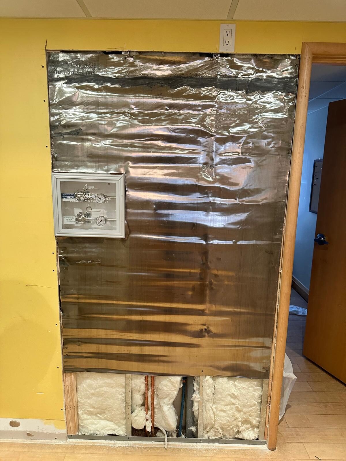 Lead sheeting applied to an imaging-room wall for radiation shielding.