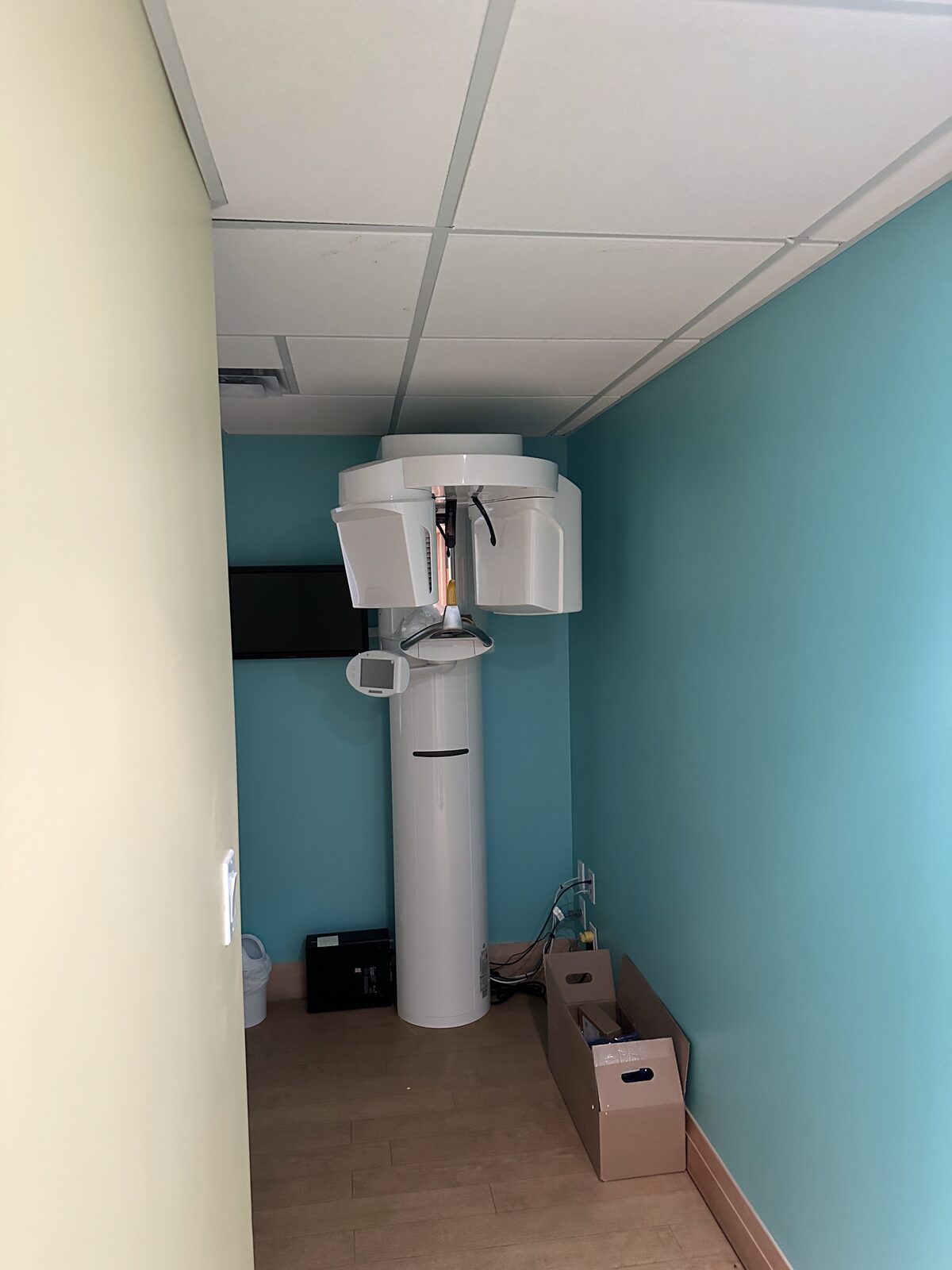 Positioning the panoramic X-ray unit during installation.