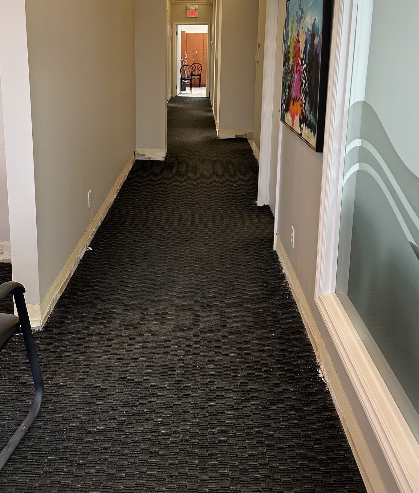 A back hallway with the worn dark carpet that was removed.