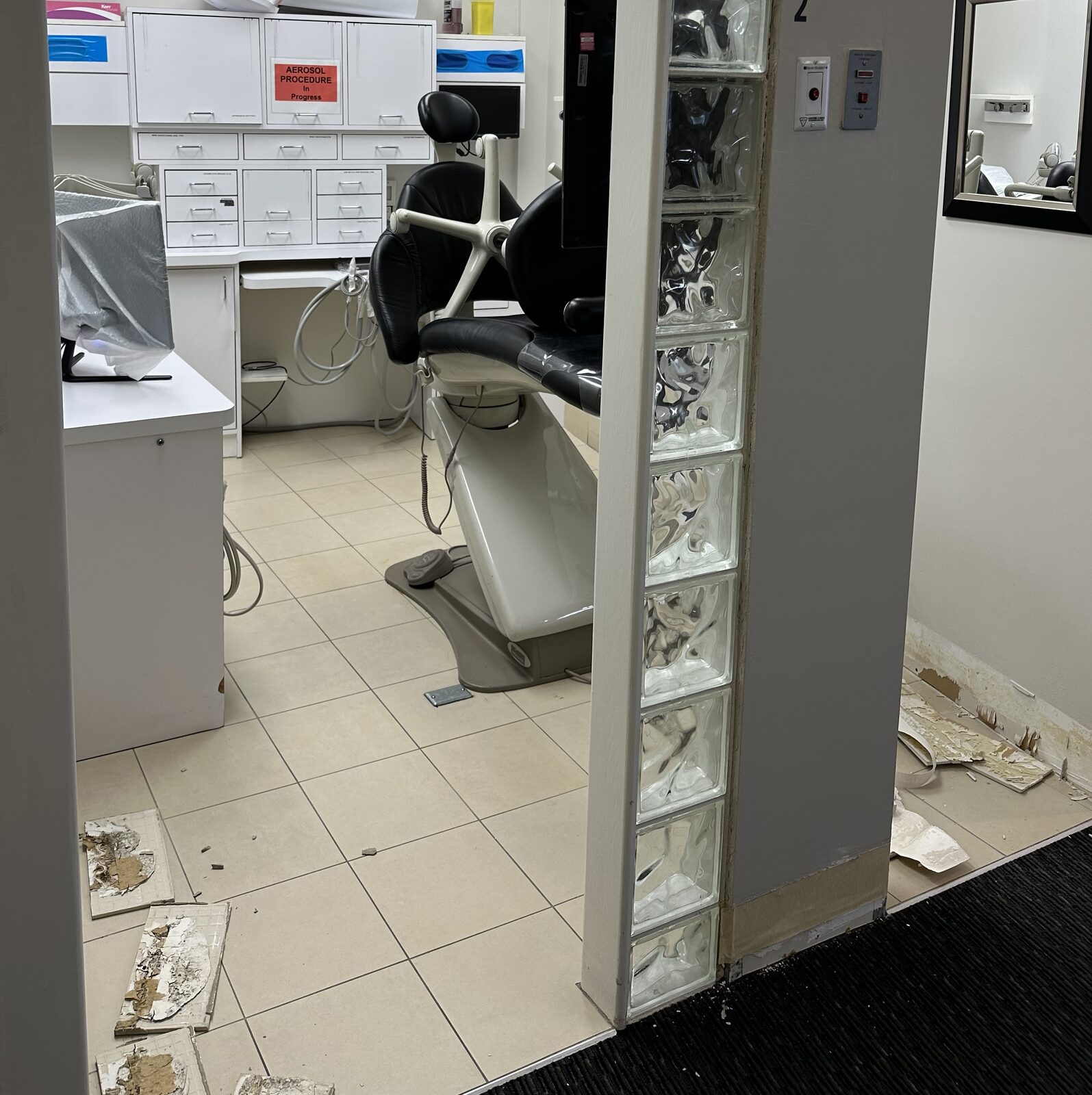 An operatory before the work, with dated ceramic tile flooring.