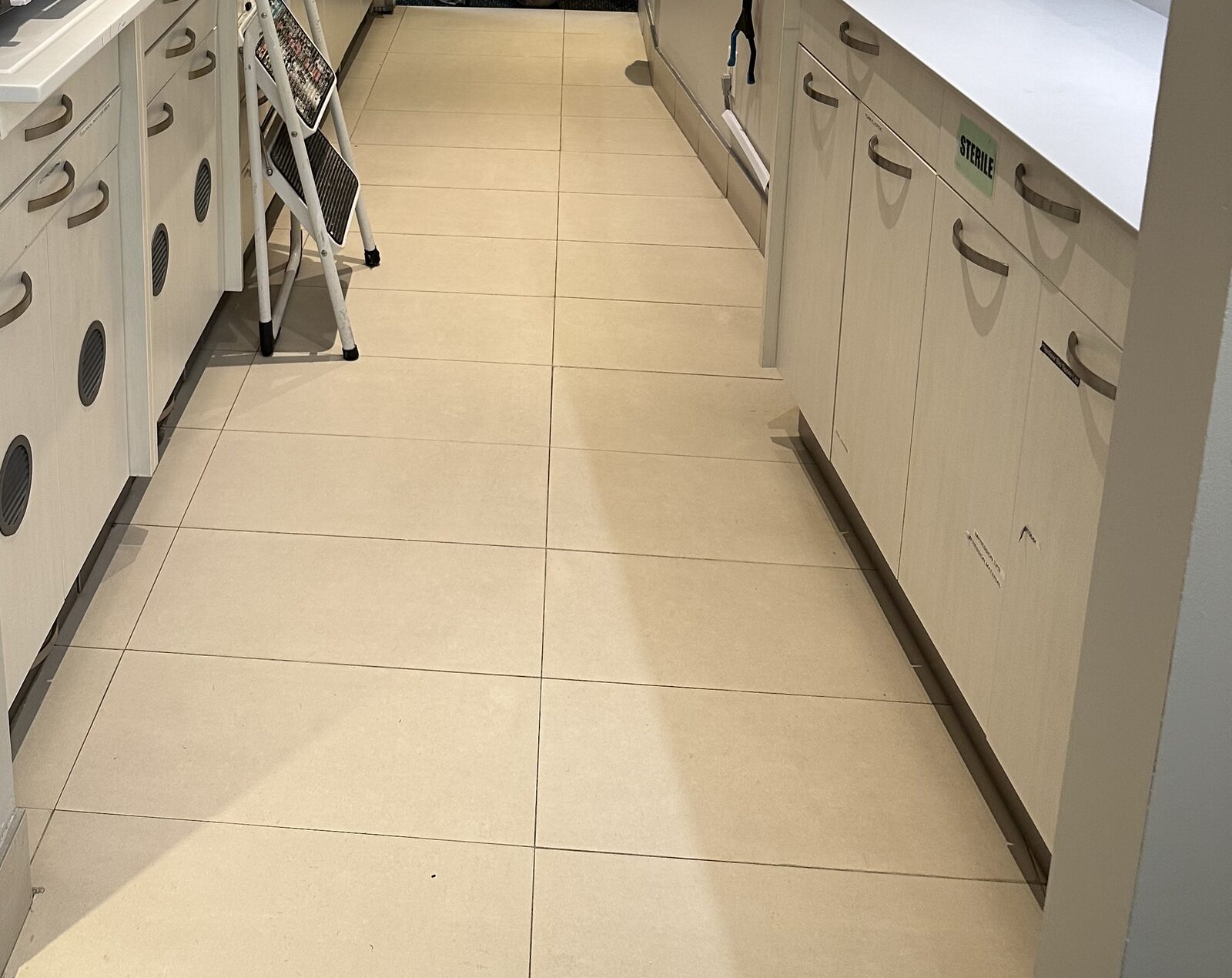 The sterilization and lab area on its original large-format tile floor.