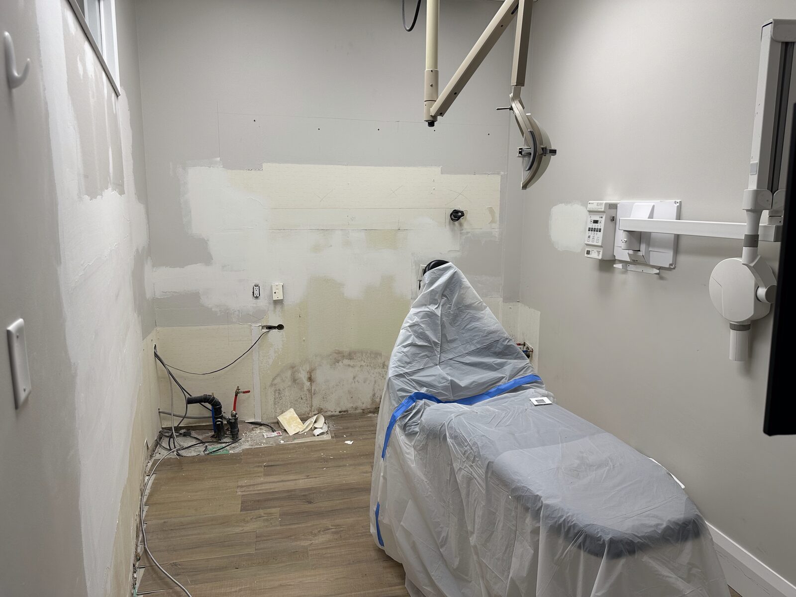 An OP1 room stripped back during demolition, equipment wrapped and protected.