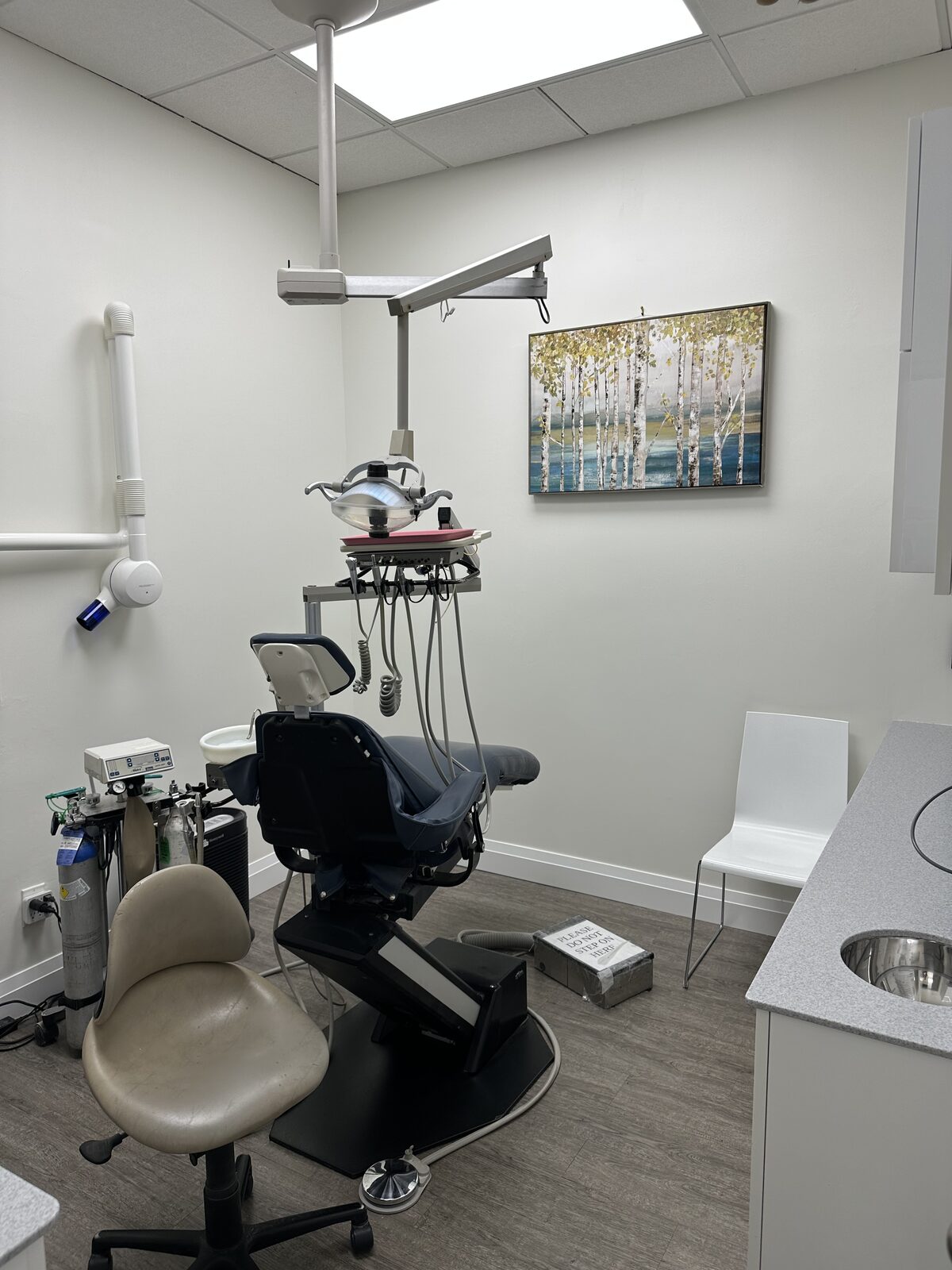 A finished operatory with fresh paint and new wall art.