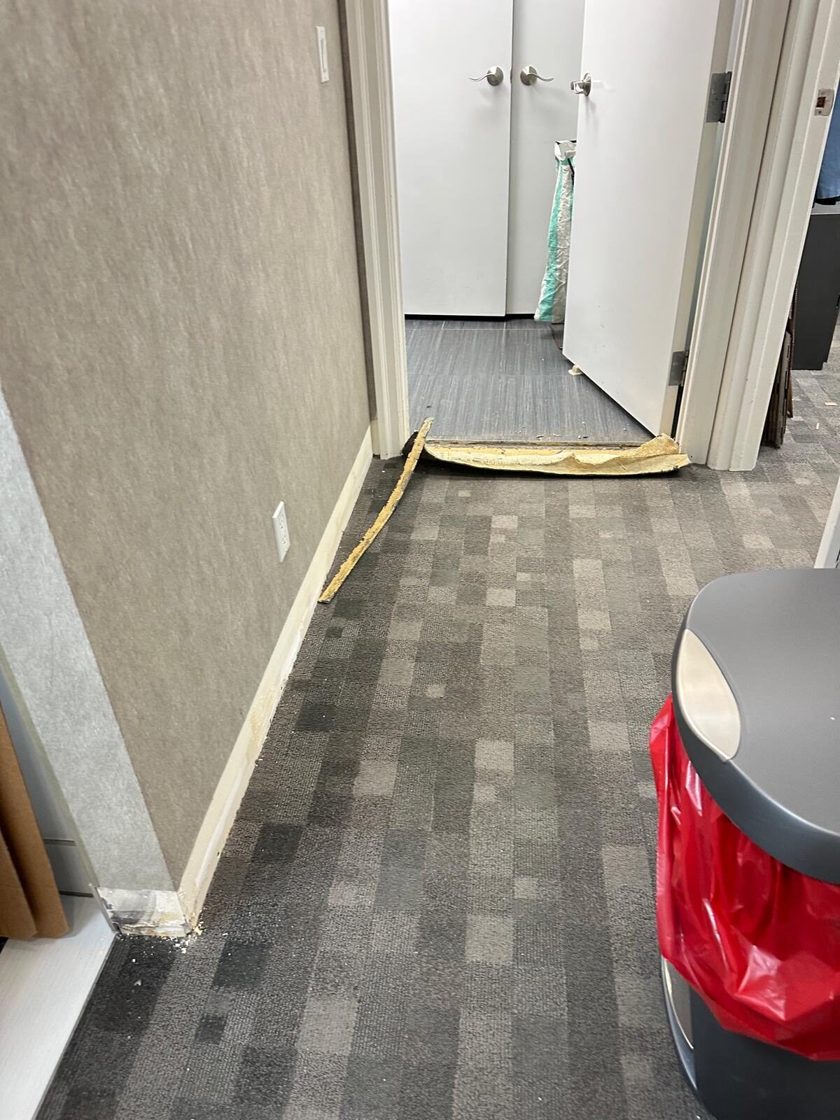 The original multi-tone carpet tile before replacement.