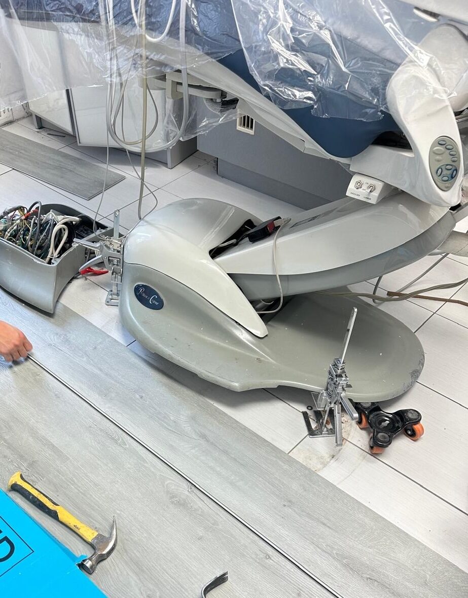 New luxury vinyl planks being laid around the dental equipment.