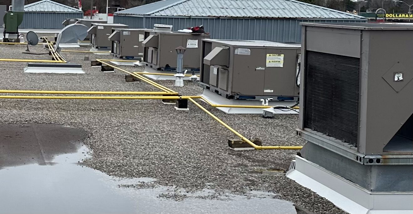 A bank of rooftop HVAC package units maintained under the program.