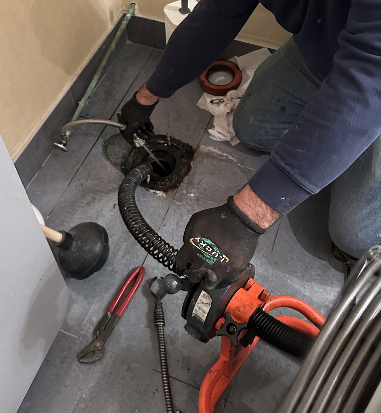 Servicing a blocked floor drain in a treatment area.