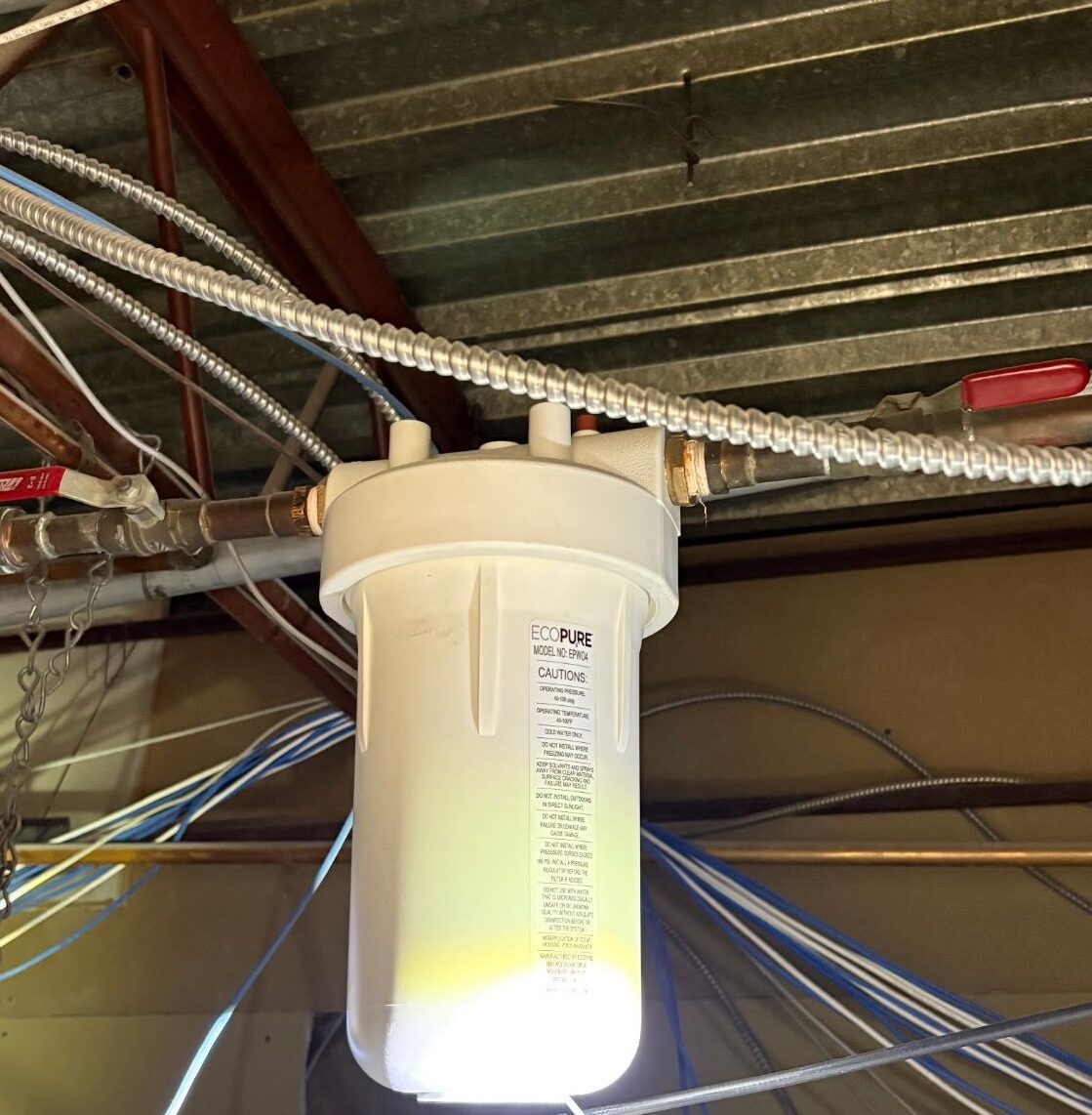 A dental water-line filtration cartridge plumbed in above the ceiling.